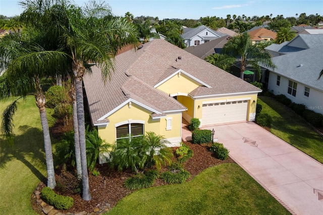 view of front of house with a garage and a front lawn