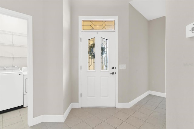 tiled entryway with washer and dryer