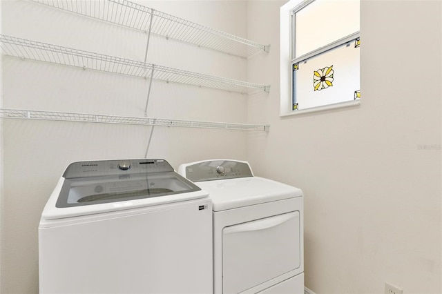 clothes washing area with washing machine and dryer