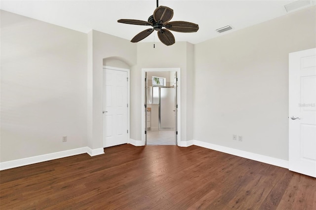 unfurnished room with ceiling fan and dark hardwood / wood-style flooring