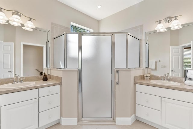 bathroom with plenty of natural light, a shower with door, and vanity