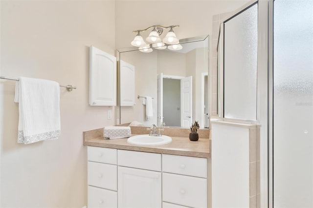 bathroom featuring vanity and a shower with door