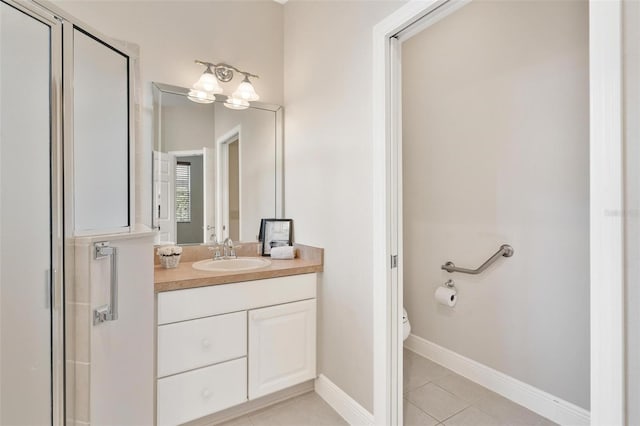 bathroom featuring tile patterned floors, toilet, a shower with shower door, and vanity