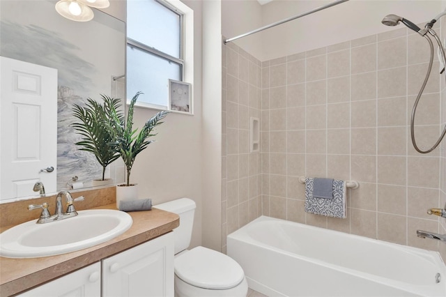 full bathroom with vanity, toilet, and tiled shower / bath combo