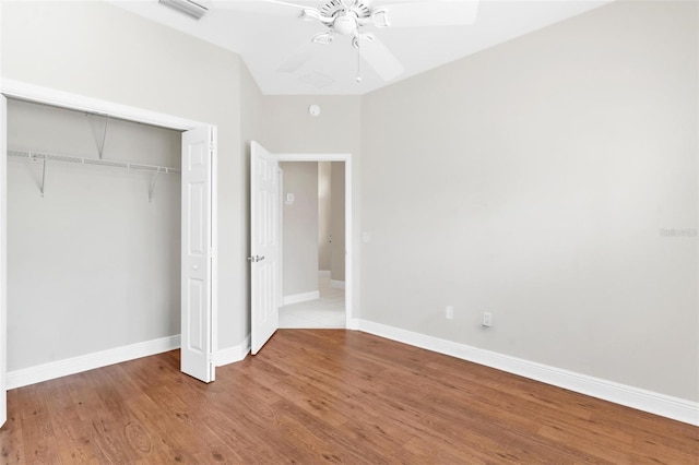 unfurnished bedroom featuring wood-type flooring, ceiling fan, and a closet