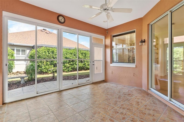 doorway to outside featuring ceiling fan