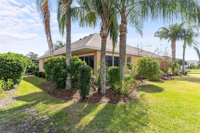 view of side of home featuring a yard