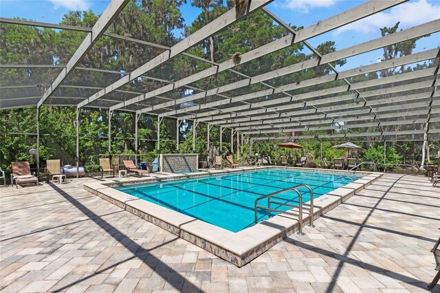 community pool featuring a patio and a lanai