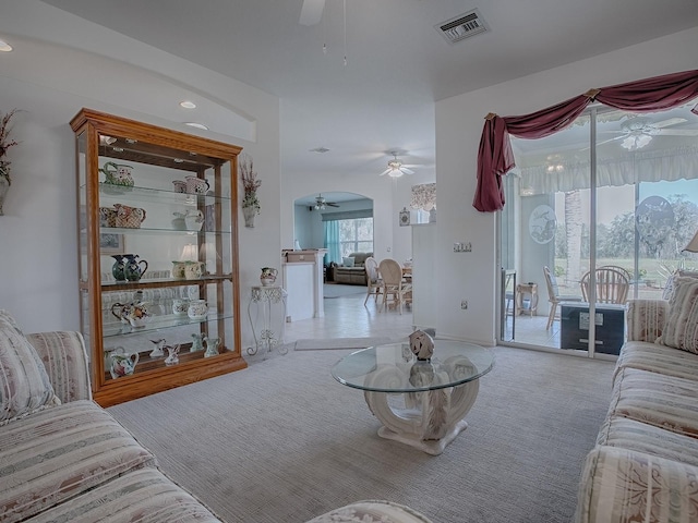 living room featuring ceiling fan and light carpet