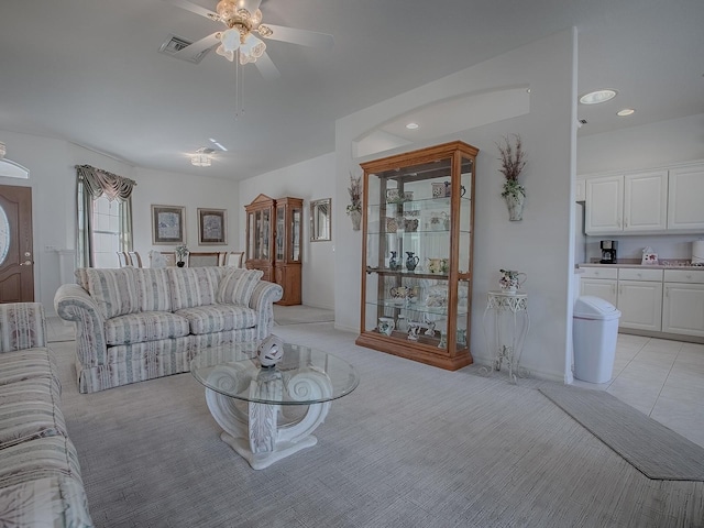 unfurnished living room featuring light carpet and ceiling fan