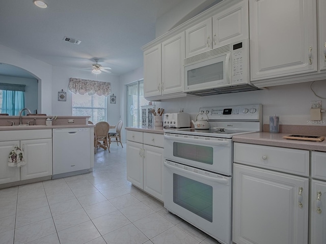 kitchen featuring sink, white cabinetry, light tile patterned floors, ceiling fan, and white appliances