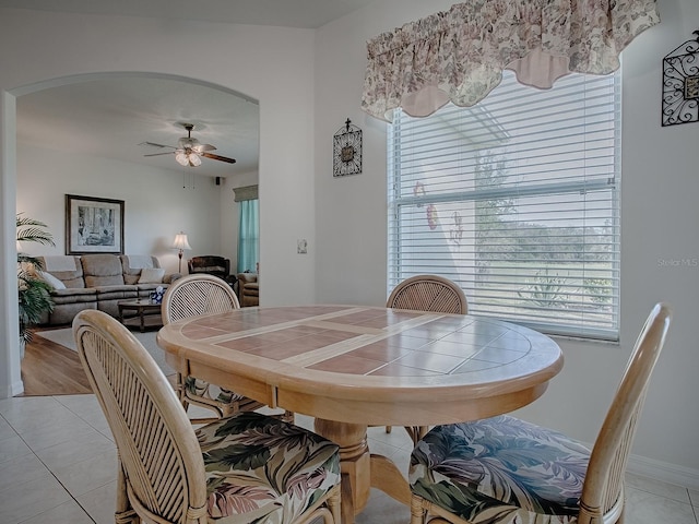 dining area featuring light tile patterned flooring and ceiling fan