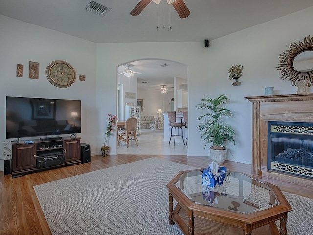 living room featuring ceiling fan and light hardwood / wood-style flooring