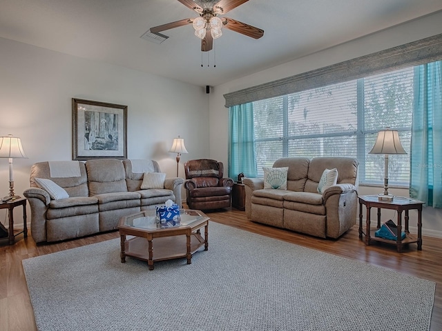 living room featuring hardwood / wood-style flooring, ceiling fan, and a healthy amount of sunlight