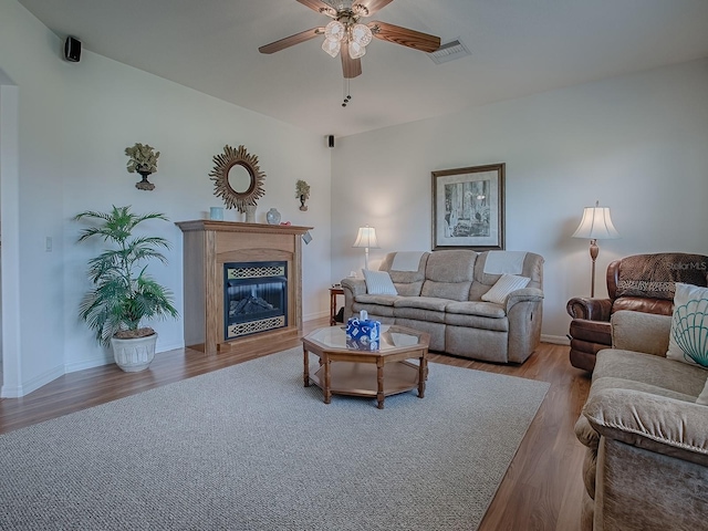 living room with ceiling fan and light hardwood / wood-style flooring