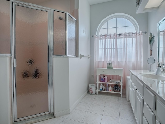 bathroom featuring vanity, an enclosed shower, and tile patterned flooring