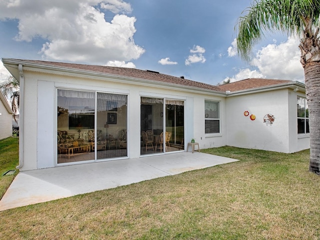 rear view of property with a patio and a yard