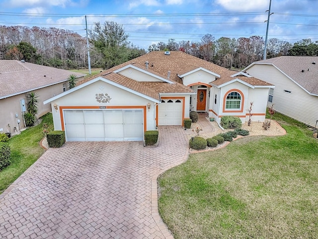 single story home with a garage and a front yard