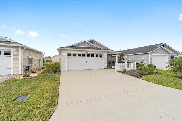 ranch-style house featuring board and batten siding, a front yard, driveway, and fence