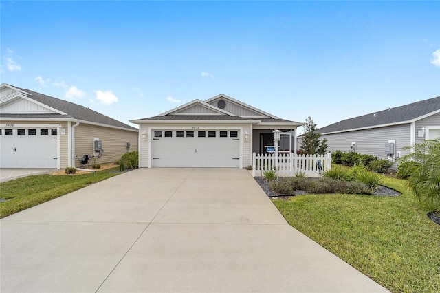 view of front facade featuring a garage, a front yard, concrete driveway, and fence