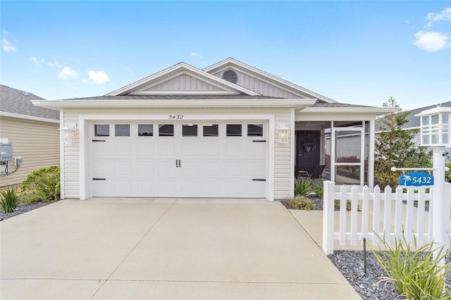 ranch-style home featuring an attached garage, fence, board and batten siding, and concrete driveway