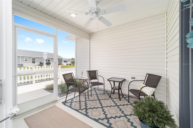 sunroom featuring a ceiling fan