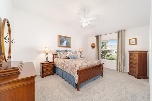 bedroom featuring light carpet, vaulted ceiling, baseboards, and ceiling fan