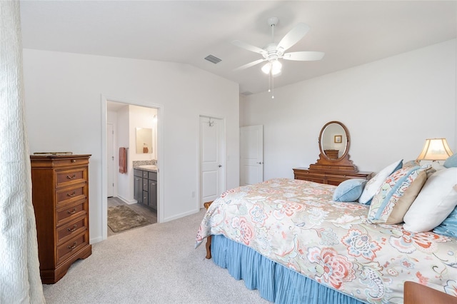 bedroom with connected bathroom, light colored carpet, a ceiling fan, visible vents, and vaulted ceiling