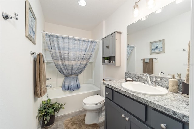 full bath with toilet, wood finished floors, shower / tub combo with curtain, and vanity