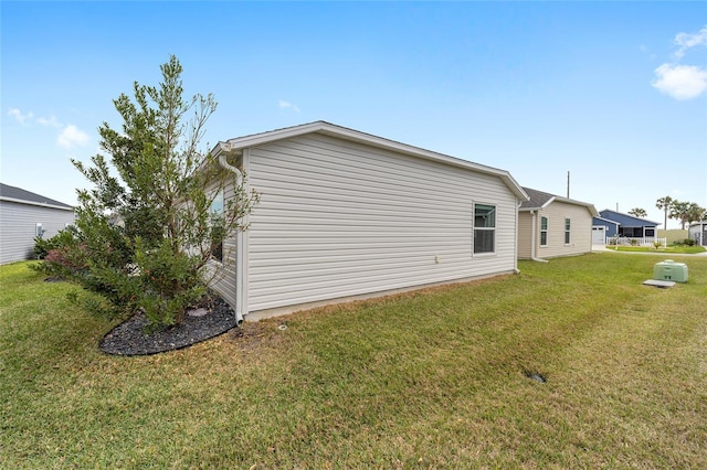 view of property exterior with a yard