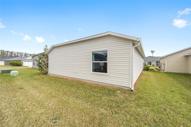 view of property exterior with a lawn