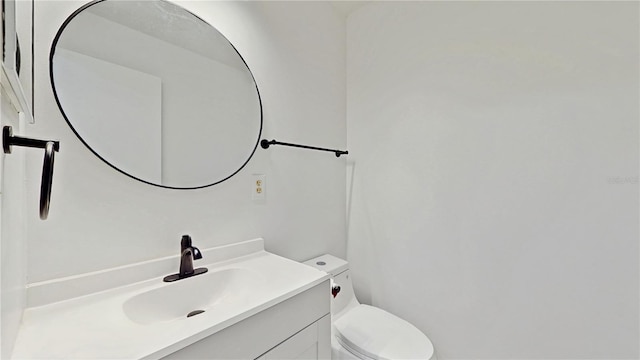 half bathroom with toilet and vanity