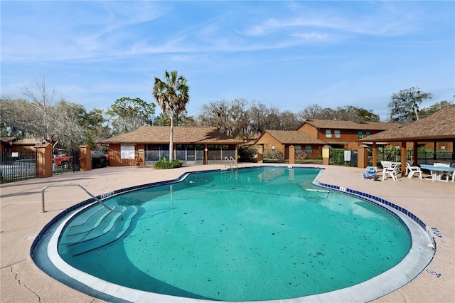 community pool featuring a patio area and fence