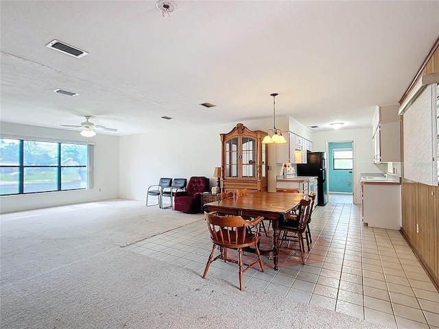 tiled dining area featuring ceiling fan and a healthy amount of sunlight