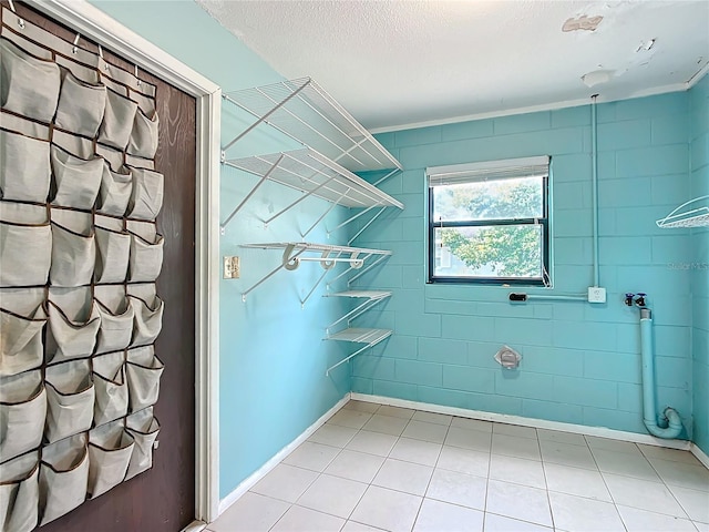 washroom featuring tile patterned flooring and a textured ceiling