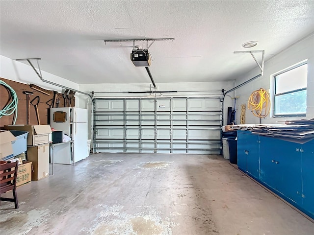 garage with white refrigerator and a garage door opener