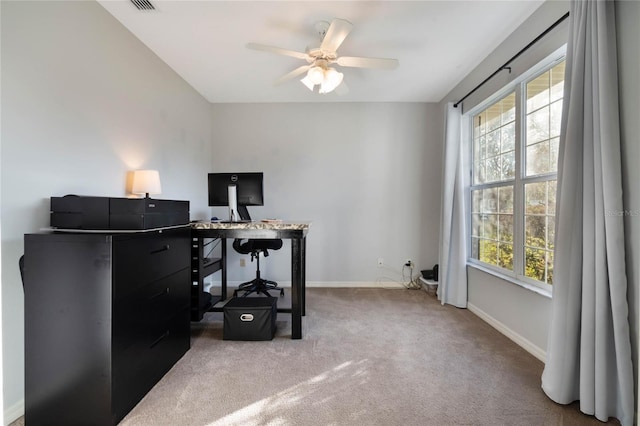 carpeted office space with ceiling fan