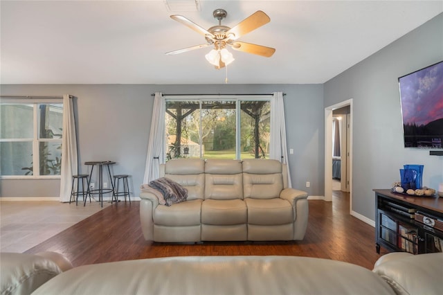 living room with hardwood / wood-style flooring and ceiling fan