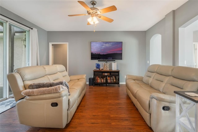 living room featuring ceiling fan and wood-type flooring