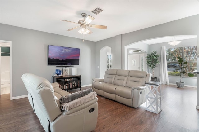 living room featuring ceiling fan and dark hardwood / wood-style flooring