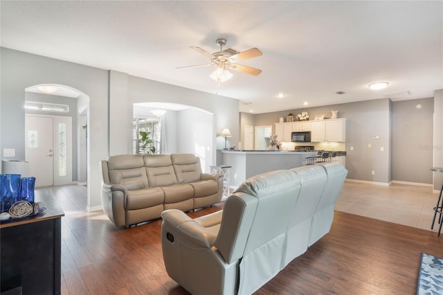 living room with hardwood / wood-style flooring and ceiling fan