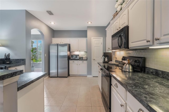 kitchen featuring light tile patterned flooring, white cabinets, decorative backsplash, and black appliances