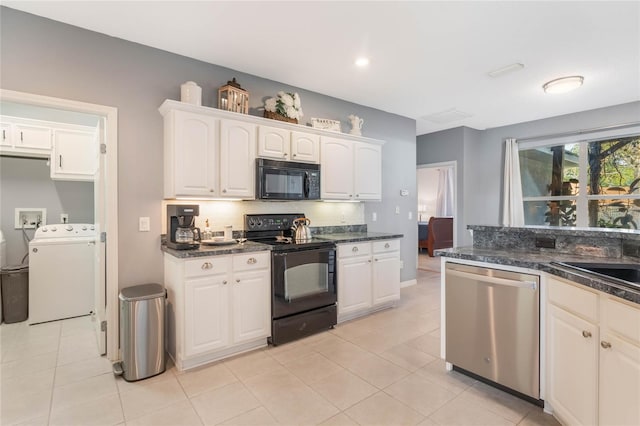 kitchen with light tile patterned flooring, white cabinetry, sink, black appliances, and washer and clothes dryer