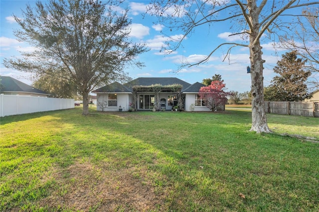 rear view of house featuring a yard