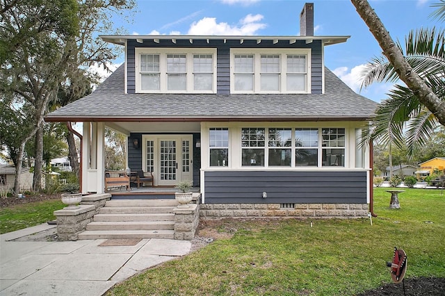 view of front of home with a front lawn and french doors