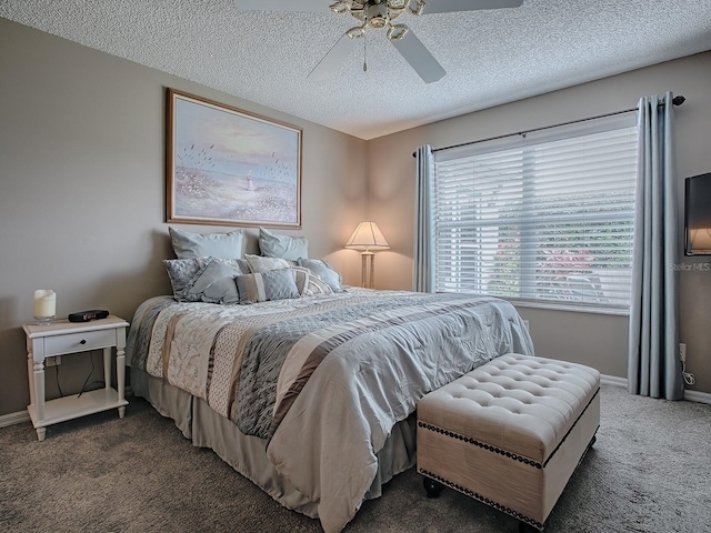 bedroom featuring a textured ceiling, dark carpet, a ceiling fan, and baseboards