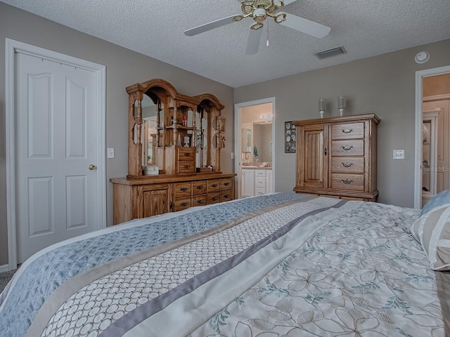bedroom featuring a textured ceiling, ceiling fan, connected bathroom, and visible vents