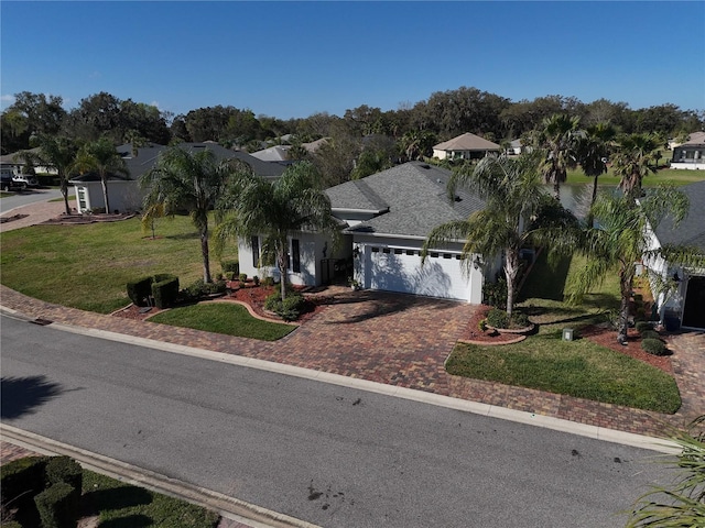 view of front of home with a front lawn and a garage