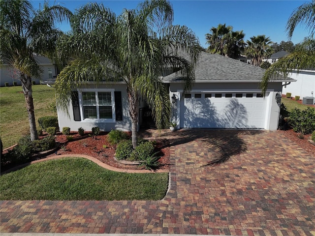 view of front of house with a front yard and a garage