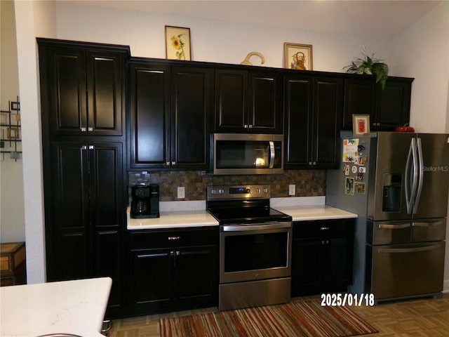 kitchen with tasteful backsplash and stainless steel appliances